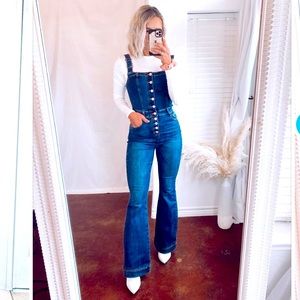 Flare button down overalls .